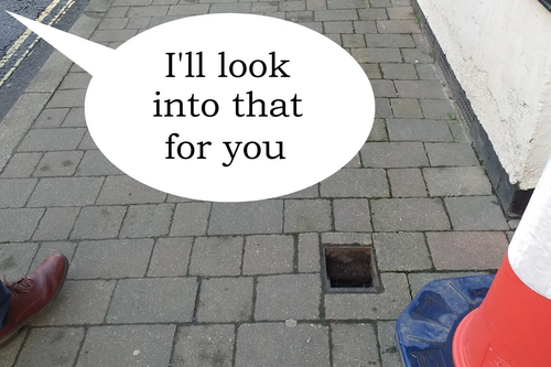 Hole in pavement with speech bubble